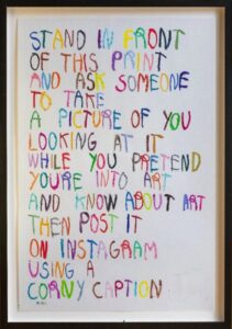 Stand in front and pretend you're into art.